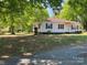 Side view of traditional home with mature trees, tidy lawn, and attractive landscape at 109 Barrett Rd, Cherryville, NC 28021