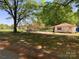 Large, well-maintained lot with detached outbuilding, mature trees, and blue sky at 109 Barrett Rd, Cherryville, NC 28021