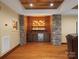 Basement bar with stone accents, wooden shelving, and built-in refrigerator, perfect for entertaining guests at 111 Milledge Dr, Mooresville, NC 28117