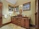 Bathroom vanity with double vessel sinks, granite countertops, custom cabinets and natural light from surrounding windows at 111 Milledge Dr, Mooresville, NC 28117