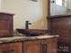 Close up on the vessel sink, granite countertops, and hardwood cabinetry in the elegant Primary bathroom at 111 Milledge Dr, Mooresville, NC 28117