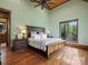 Cozy bedroom featuring large windows with natural light, hardwood floors and a ceiling fan at 111 Milledge Dr, Mooresville, NC 28117