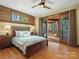 Bright bedroom with wood accents, a ceiling fan, and patio access with beautiful views at 111 Milledge Dr, Mooresville, NC 28117