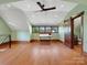 Bright bonus room features hardwood floors, a unique ceiling fan, large windows, and a charming sliding barn door at 111 Milledge Dr, Mooresville, NC 28117