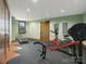 Spacious exercise room with various equipment and a window overlooking a green space at 111 Milledge Dr, Mooresville, NC 28117