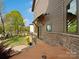Exterior view of home with stone accents, landscaping, and view of the lake at 111 Milledge Dr, Mooresville, NC 28117