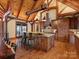Open kitchen with a breakfast bar, wooden beams, and views of the outdoors at 111 Milledge Dr, Mooresville, NC 28117