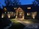 Stunning exterior view of a well-lit home with stone accents and landscaped pathway at 111 Milledge Dr, Mooresville, NC 28117