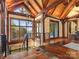 Spacious living room with vaulted wood ceilings, timber beams, large windows, and lake views at 111 Milledge Dr, Mooresville, NC 28117