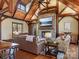 Spacious living room features a stone fireplace, wood beams, and hardwood floors, creating a cozy atmosphere at 111 Milledge Dr, Mooresville, NC 28117