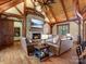 Cozy living room with a stone fireplace, exposed beams, and comfortable leather seating at 111 Milledge Dr, Mooresville, NC 28117