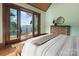 Main bedroom with deck access boasts hardwood floors and a comfortable space to relax and enjoy the outdoors at 111 Milledge Dr, Mooresville, NC 28117