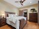 Warm and inviting main bedroom with wood furnishings and soft bedding, creating a relaxing and comfortable retreat at 111 Milledge Dr, Mooresville, NC 28117