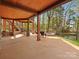 Spacious outdoor patio with a fire pit, lake access, and outdoor seating at 111 Milledge Dr, Mooresville, NC 28117