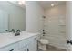 Bathroom featuring a tub-shower combination, white vanity with black hardware, and neutral-toned tile flooring at 1121 Red River Dr, Salisbury, NC 28144