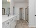 Modern bathroom featuring double vanity sinks, a shower with glass door, and a separate toilet room at 1121 Red River Dr, Salisbury, NC 28144