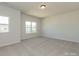Spacious bedroom filled with natural light from two windows, freshly painted in neutral tones and plush carpet at 1121 Red River Dr, Salisbury, NC 28144