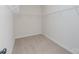 Walk-in closet featuring built-in shelving and neutral carpeting, offering ample storage space at 1121 Red River Dr, Salisbury, NC 28144