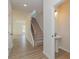 Inviting entryway with wood-look flooring, a staircase, and a convenient half-bathroom on the main floor at 1121 Red River Dr, Salisbury, NC 28144