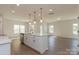 Open concept kitchen with stainless steel appliances and a modern island overlooking the living area at 1121 Red River Dr, Salisbury, NC 28144