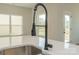 Close-up of a kitchen island featuring a modern faucet and sink, complemented by ample natural light at 1121 Red River Dr, Salisbury, NC 28144