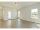 Bright living area featuring sleek wood-look flooring, large windows and a seamless transition to the backyard at 1121 Red River Dr, Salisbury, NC 28144