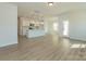Bright, open-concept floor plan with wood-look flooring and a seamless flow between living and kitchen spaces at 1121 Red River Dr, Salisbury, NC 28144