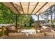 Inviting back deck with cushioned seating area and a shaded pergola, great for outdoor relaxation at 114 Rolling Stone Ct, Mooresville, NC 28117