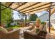 Outdoor deck with comfortable seating, a covered pergola, and backyard views offers a private relaxation and entertainment space at 114 Rolling Stone Ct, Mooresville, NC 28117