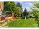 Large backyard with a deck, patio set, and a trampoline, perfect for entertaining at 114 Rolling Stone Ct, Mooresville, NC 28117