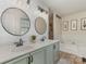 Bathroom with double sinks, modern mirrors, tub, separate shower, and stylish decorative touches at 114 Rolling Stone Ct, Mooresville, NC 28117