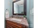 Stylish bathroom features a granite countertop, modern faucet, and framed mirror that enhances the space's contemporary appeal at 114 Rolling Stone Ct, Mooresville, NC 28117