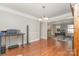 Spacious dining room with hardwood floors transitions seamlessly into a brightly lit playroom at 114 Rolling Stone Ct, Mooresville, NC 28117