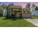 Charming two-story home with a well-manicured lawn and colorful landscaping, inviting front porch, and two-car garage at 114 Rolling Stone Ct, Mooresville, NC 28117