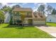Charming two-story home with a well-manicured lawn and colorful landscaping, inviting front porch, and two-car garage at 114 Rolling Stone Ct, Mooresville, NC 28117