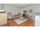 Bright living room features hardwood floors, neutral walls, and archway to dining space filled with ' toys at 114 Rolling Stone Ct, Mooresville, NC 28117