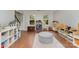 Sunlit living room boasts hardwood floors and multiple storage solutions perfect for ' toys and accessories at 114 Rolling Stone Ct, Mooresville, NC 28117