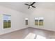 Bedroom featuring vaulted ceiling, three large windows with views, and wood-look flooring at 120 Southern Oaks Ln, Salisbury, NC 28147