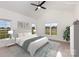 Bright, staged main bedroom with vaulted ceiling, ceiling fan, and pastoral views through large windows at 120 Southern Oaks Ln, Salisbury, NC 28147