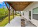 An expansive covered patio area, featuring a stone fire pit and view of the backyard at 12305 Stinson Ct, Charlotte, NC 28277