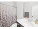 Cozy bathroom with a floral shower curtain, white vanity, and a mirror, offering a clean and functional space at 12305 Stinson Ct, Charlotte, NC 28277