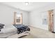 Bright bedroom with two windows dressed with floral curtains at 12305 Stinson Ct, Charlotte, NC 28277