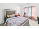Well lit bedroom with decorative pillows and floral bedding at 12305 Stinson Ct, Charlotte, NC 28277