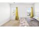 A light filled bedroom has neutral walls and carpet plus yellow floral curtains at 12305 Stinson Ct, Charlotte, NC 28277