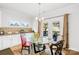 Bright dining area with a glass table, elegant chairs, and access to outdoor patio at 12305 Stinson Ct, Charlotte, NC 28277