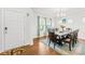 A formal dining room featuring hardwood floors, a modern chandelier, and seating for eight at 12305 Stinson Ct, Charlotte, NC 28277
