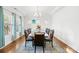 Elegant dining room showcasing a tray ceiling, bright natural light, and seating for eight at 12305 Stinson Ct, Charlotte, NC 28277