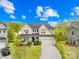 Charming two-story home with a well-manicured lawn, a covered porch, and a two-car garage at 12305 Stinson Ct, Charlotte, NC 28277