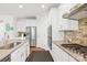 Modern kitchen with stainless steel appliances, white cabinets, and granite countertops at 12305 Stinson Ct, Charlotte, NC 28277