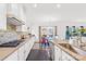 Well-lit kitchen featuring white cabinets, modern appliances, and an adjacent dining area at 12305 Stinson Ct, Charlotte, NC 28277